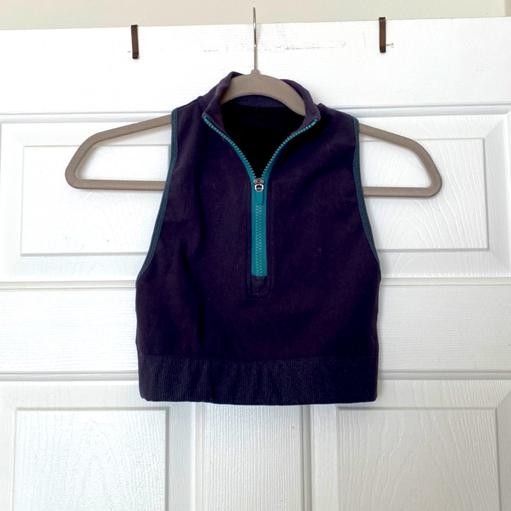Fabletics zip up high neck crop with cutout details in back.